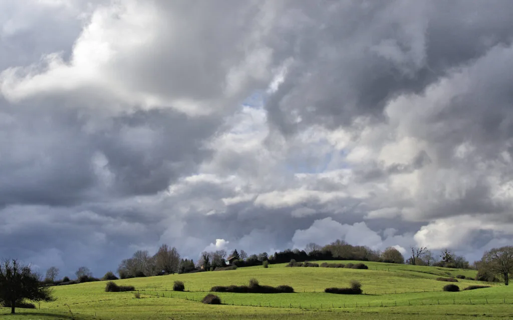 23 - Coteaux tourmentés – Ciel de traîne sur les courbes herbeuses